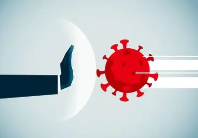 a hand making a "stop" signal at an incoming coronavirus particle